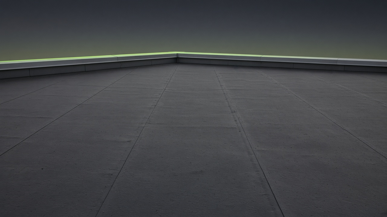 Dusk view of a low-slope commercial roof with a lime rim along the parapet